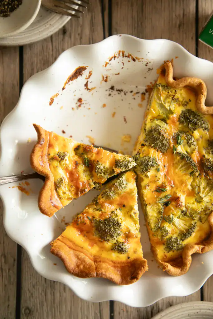 ceramic white pie pan with sliced quiche