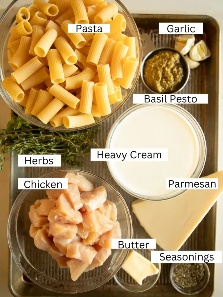 sheet pan with portioned and labeled ingredients for the chicken pesto pasta