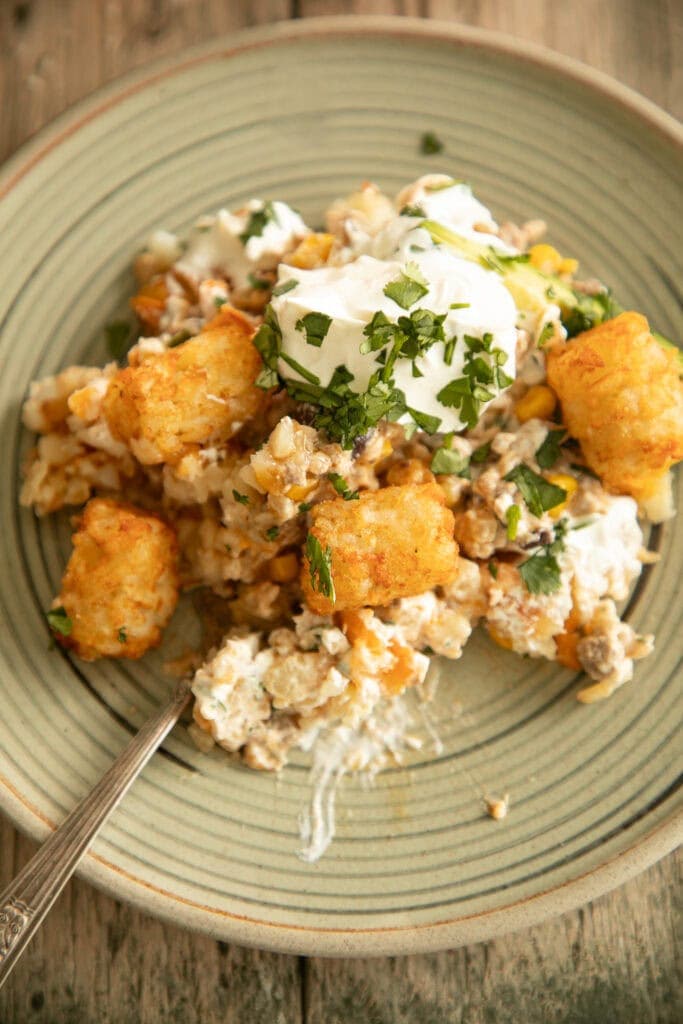 Small plate loaded with a scoop of Mexican tater tot casserole