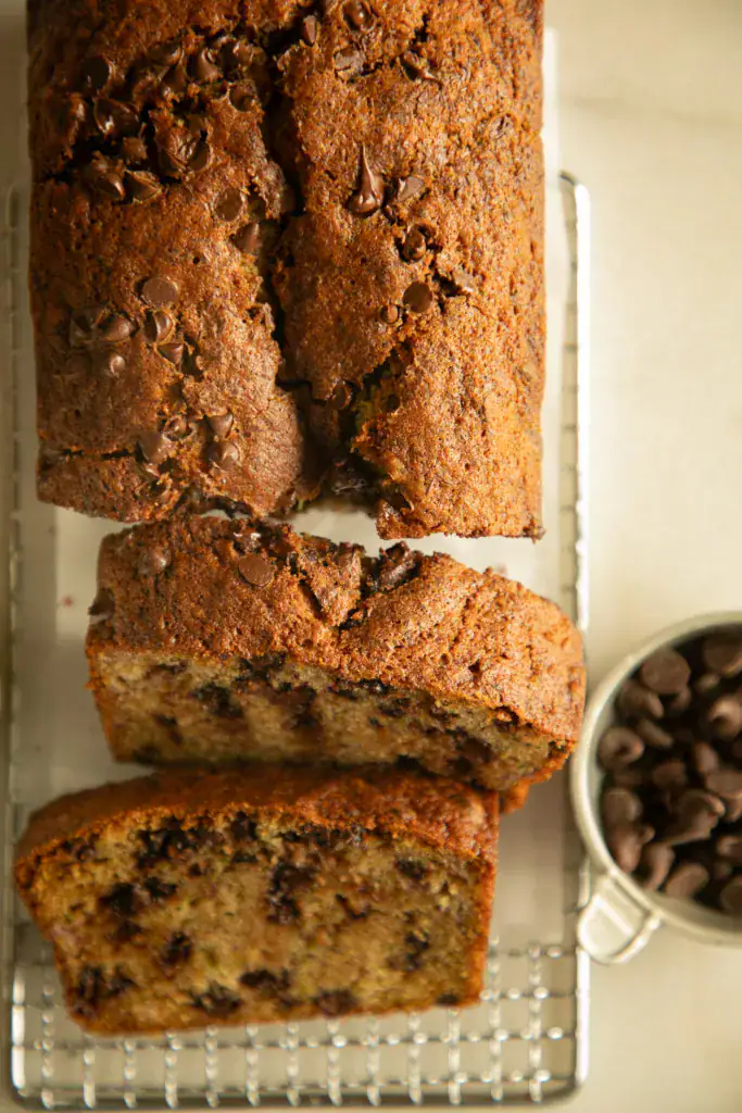 Zucchini banana loaf with chocolate chips sliced on parchment paper