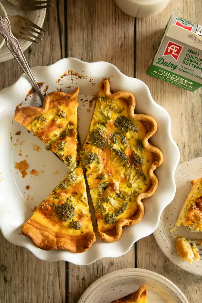 ceramic pie pan with sliced quiche