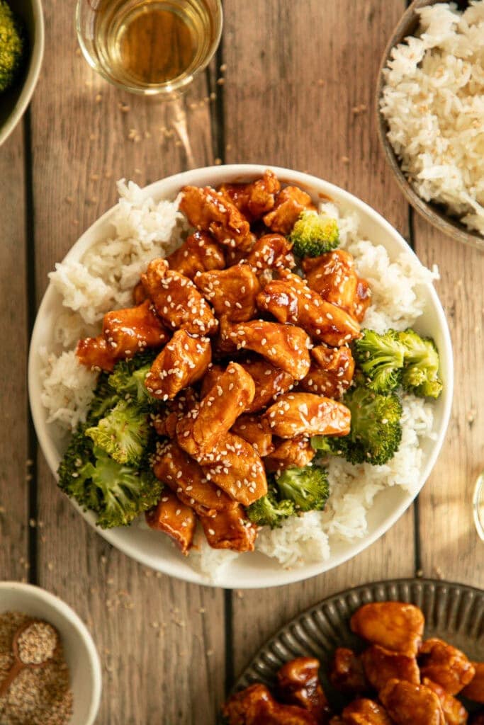large bowl of rice topped with air fryer crispy sweet and sour chicken