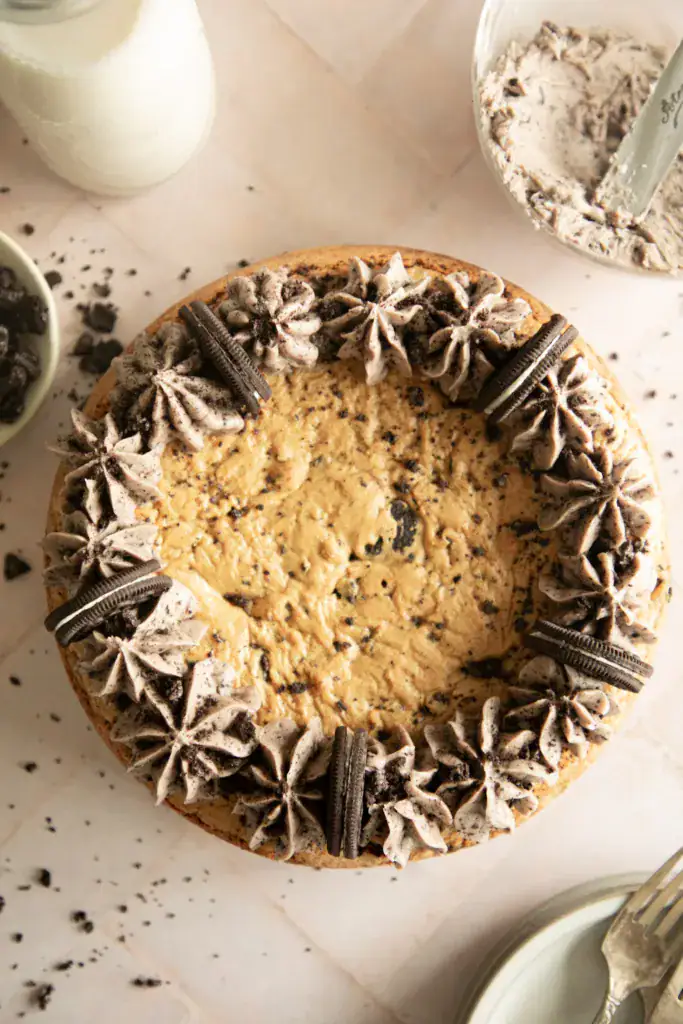 round Oreo cookie cake topped with buttercream frosting