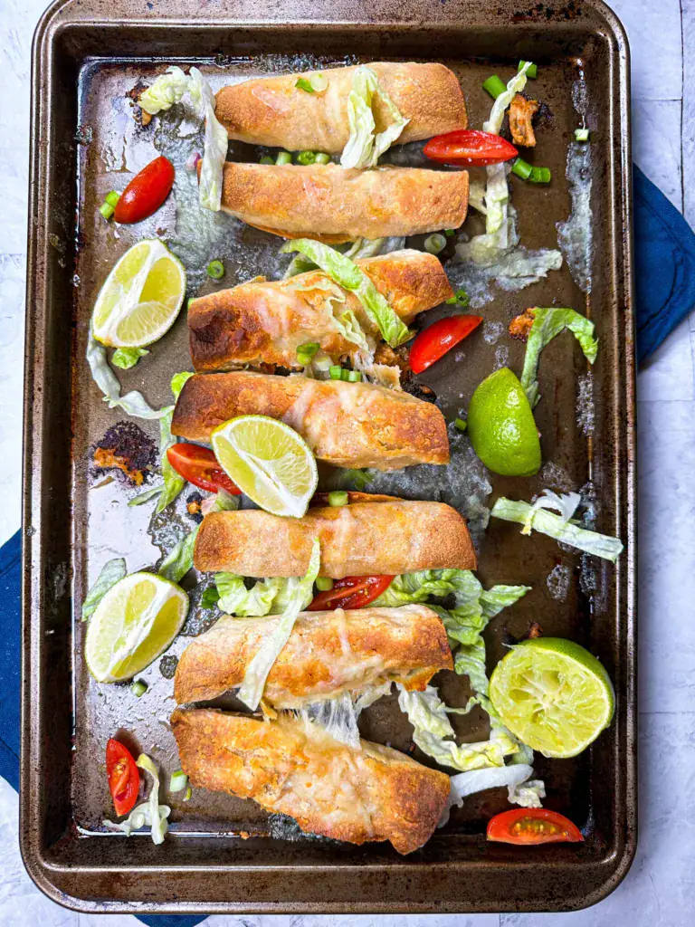 baked chicken taquitos on a pan