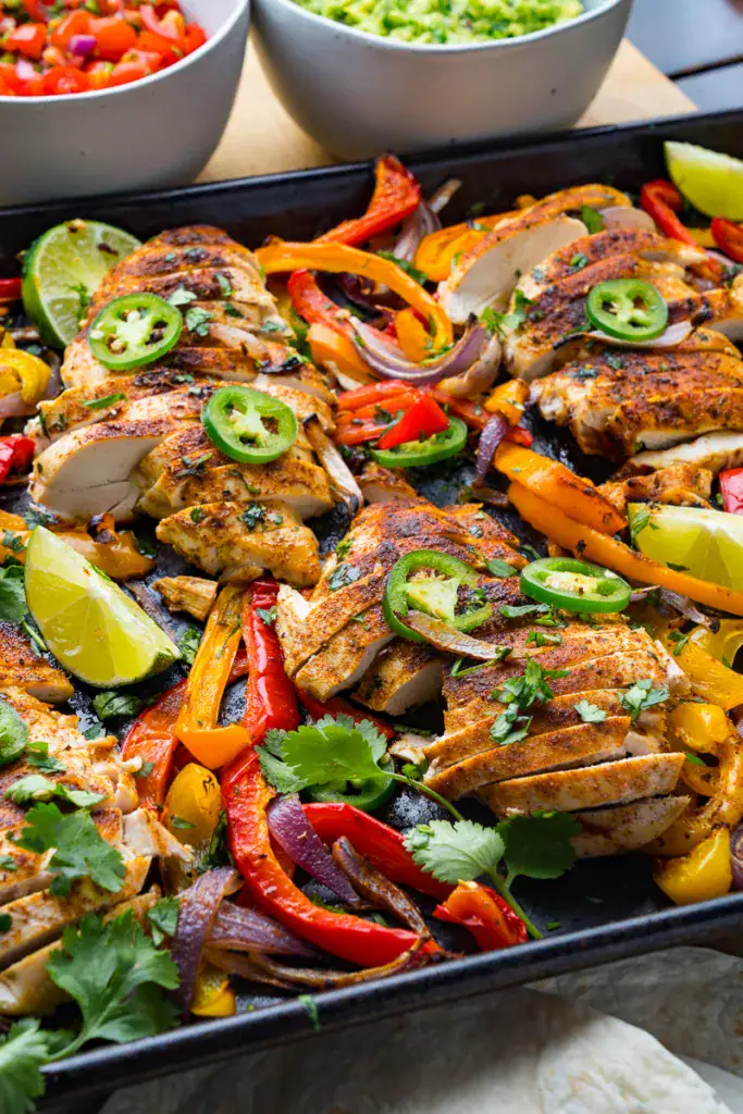 chicken and peppers on a pan