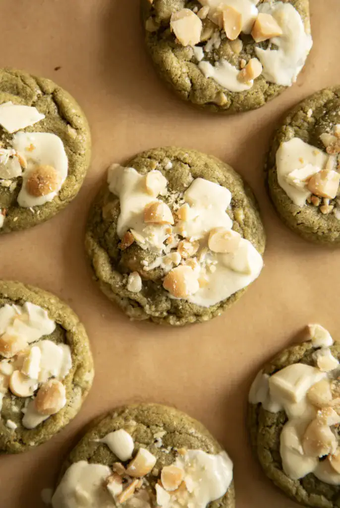 Fresh baked matcha cookies topped with chopped macadamia nuts