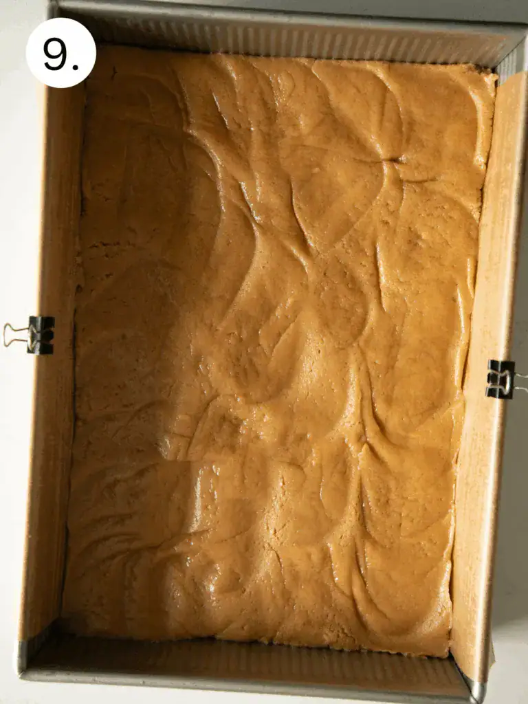 Step 9 on how to make the bars with peanut butter dough in a greased pan