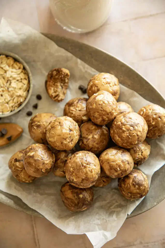 metal tray full of protein bites and a glass of milk