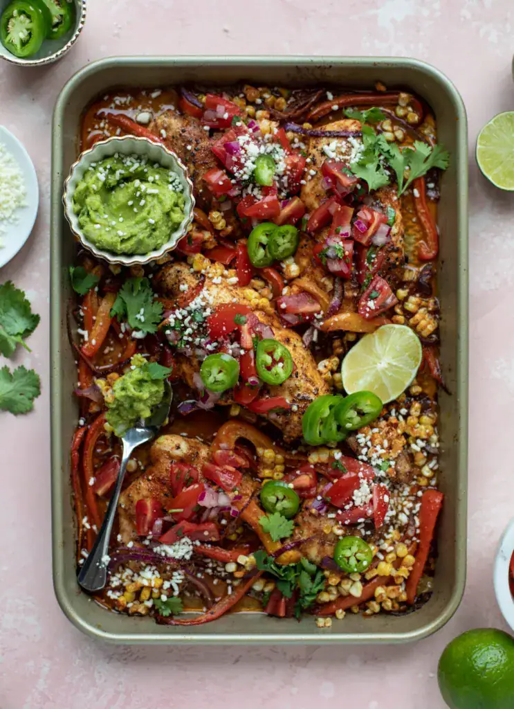 Sheet pan with seasonsed chicken breasts and peppers