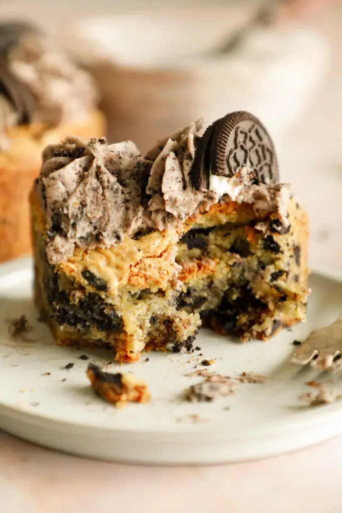 Slice or Oreo cookie cake on a small plate with bites taken out