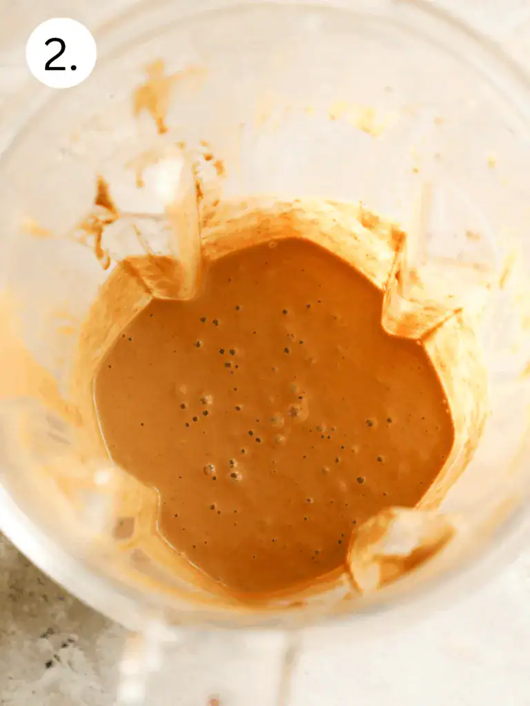 Thick chocolate smoothie blended until smooth in a clear blender.