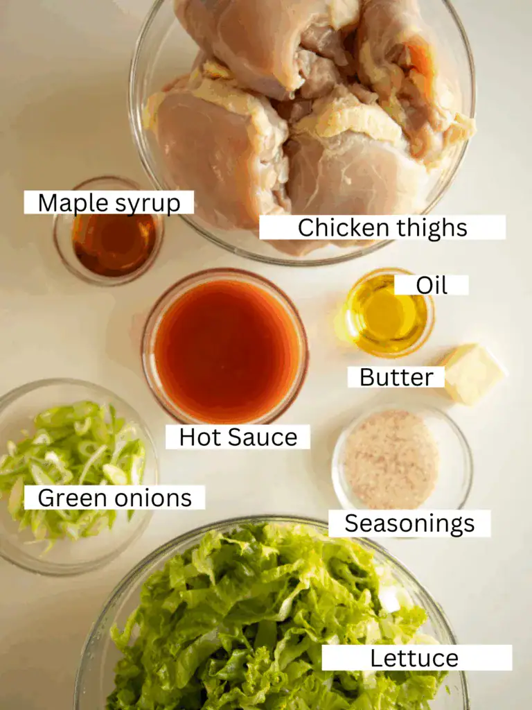 Ingredients laid out: chicken, sauce, seasonings, and lettuce