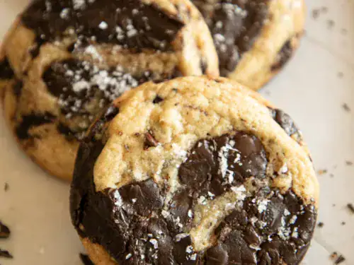 Stacked chocolate chunk cookies with crisp edges and gooey centers.