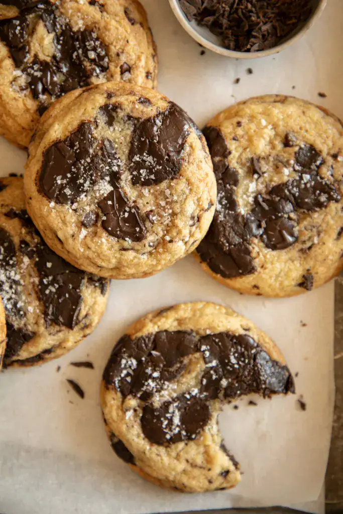Close-up of a tahini cookie with a bite taken out.
