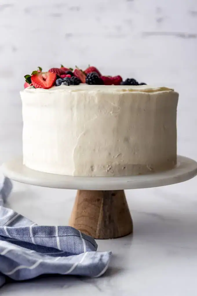 round cake frosted and with berries