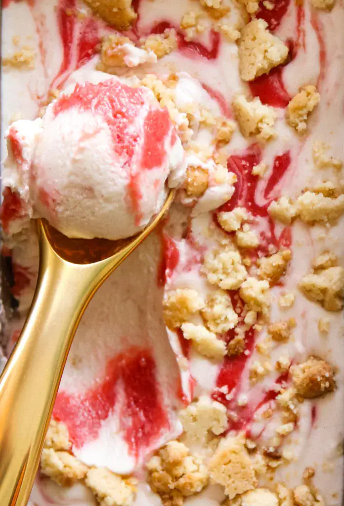 swirled rhubarb ice cream in a pan with pie crumbles