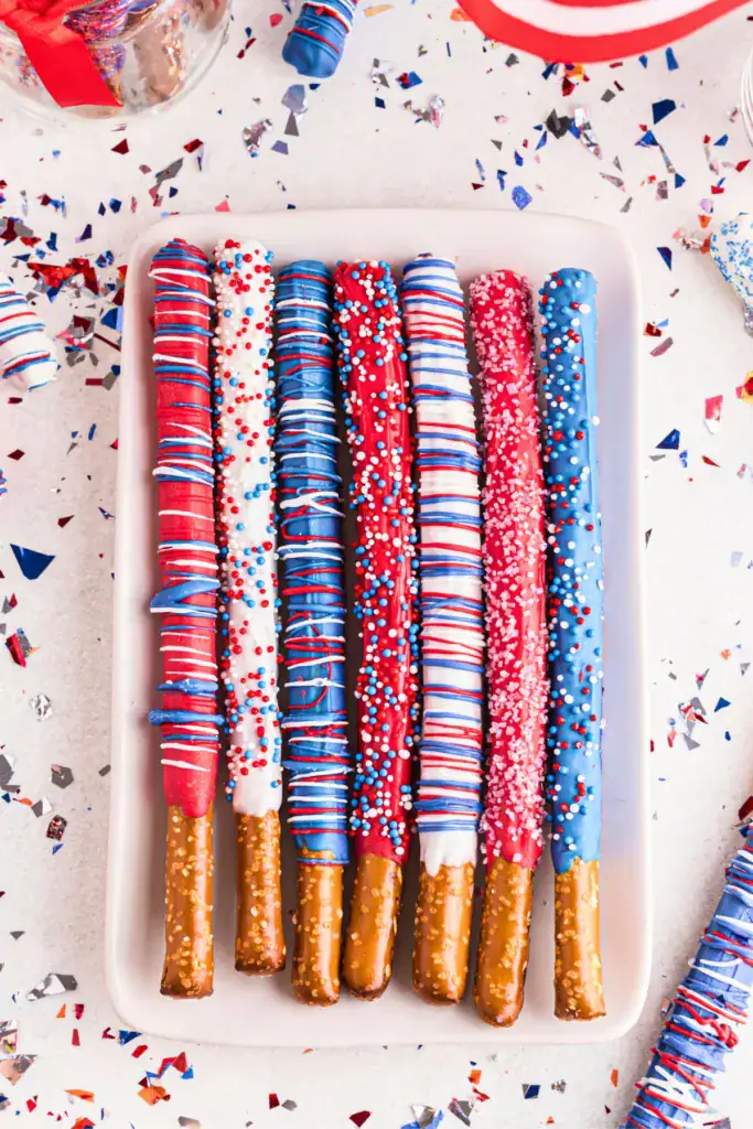 festive dipped pretzel rods with red white and blue decorations