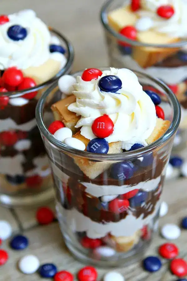 glass jars full of hot fudge trifles