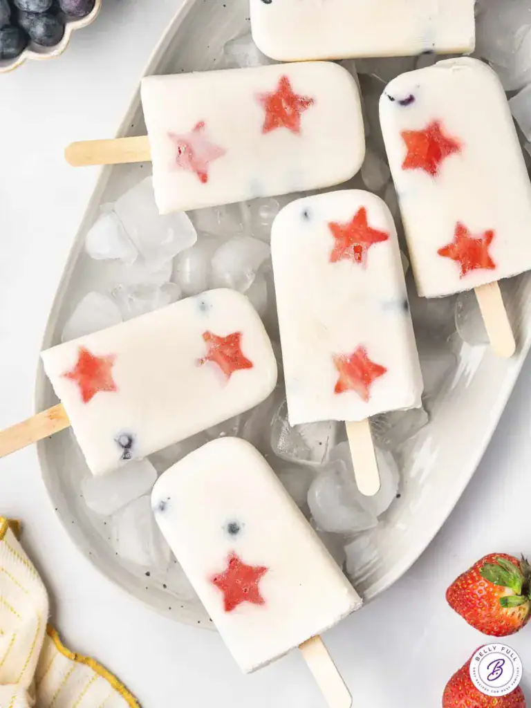 red white and blue popsicles over a tray of ice