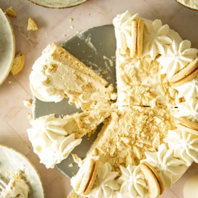 Overhead close-up of full frozen Golden Oreo pie topped with crushed cookies and piped whipped cream rosettes
