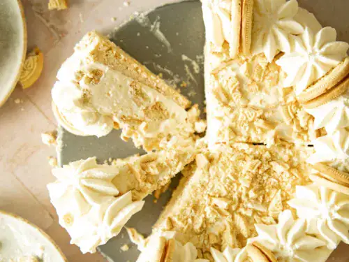 Overhead close-up of full frozen Golden Oreo pie topped with crushed cookies and piped whipped cream rosettes