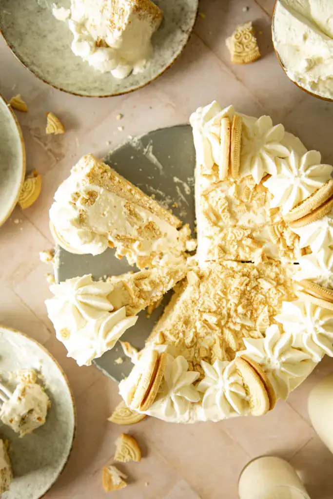 Overhead close-up of full frozen Golden Oreo pie topped with crushed cookies and piped whipped cream rosettes