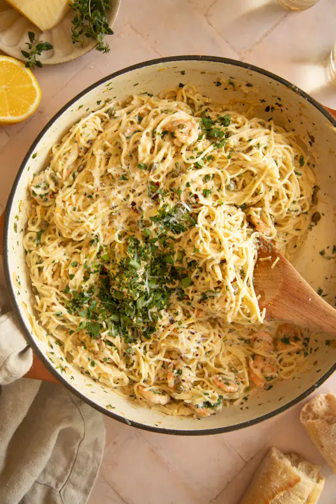 Creamy shrimp scampi pasta with parsley in a large skillet, ready to serve.