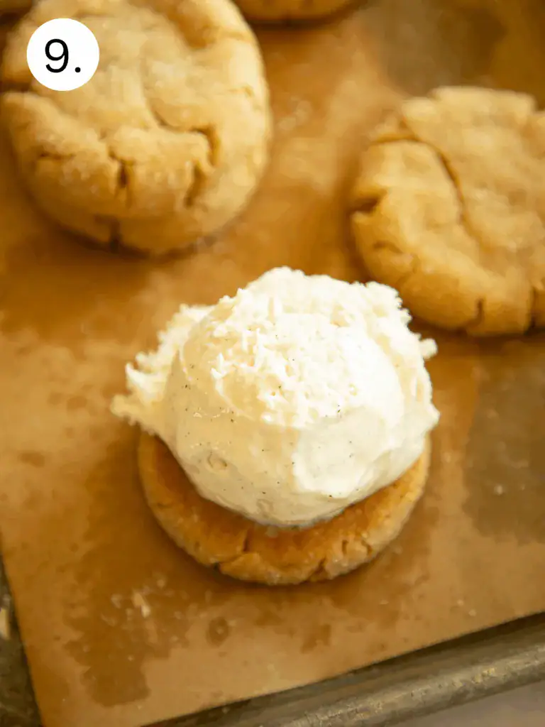 Step showing vanilla ice cream topped with strawberry jelly before being sandwiched between peanut butter cookies