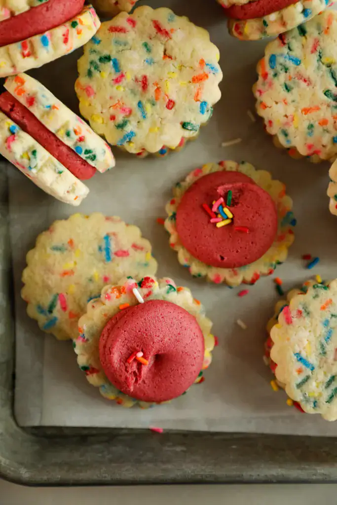 Frosted shortbread cookies on a sheet pan
