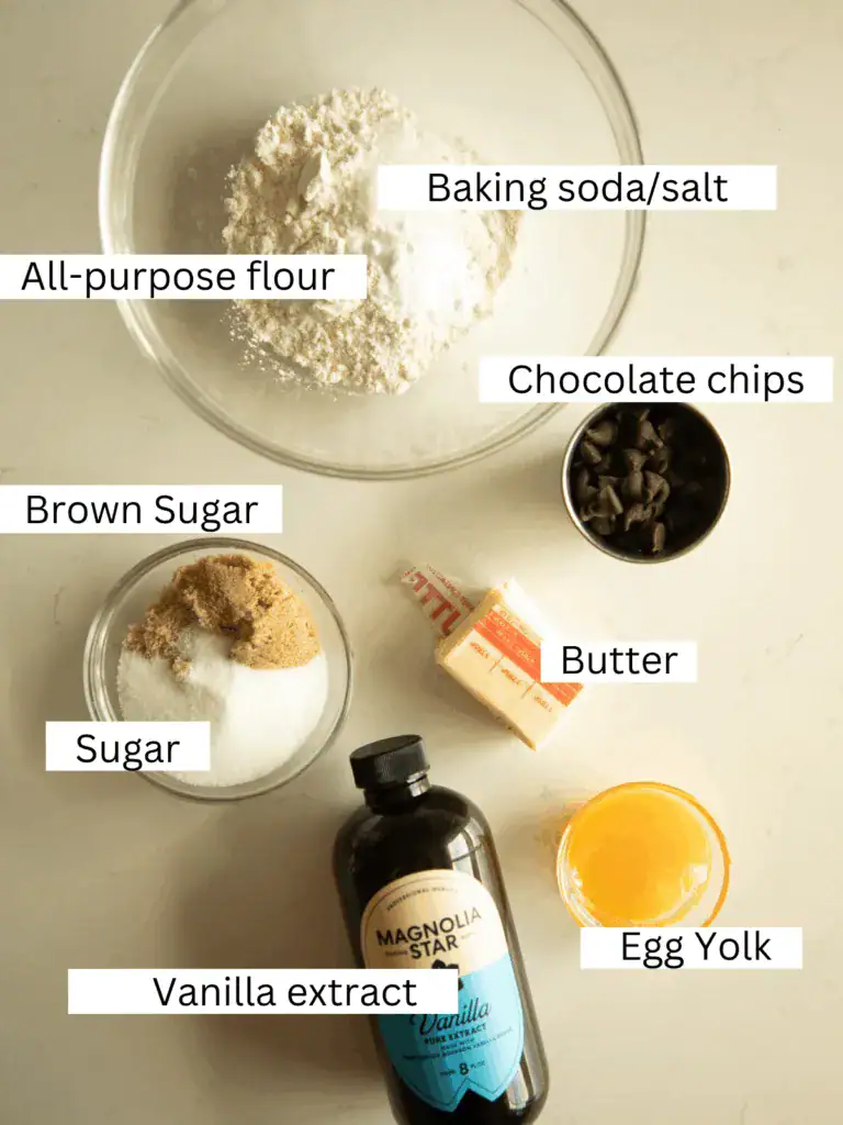 Overhead view of small batch cookie ingredients including flour, sugars, butter, and egg yolk