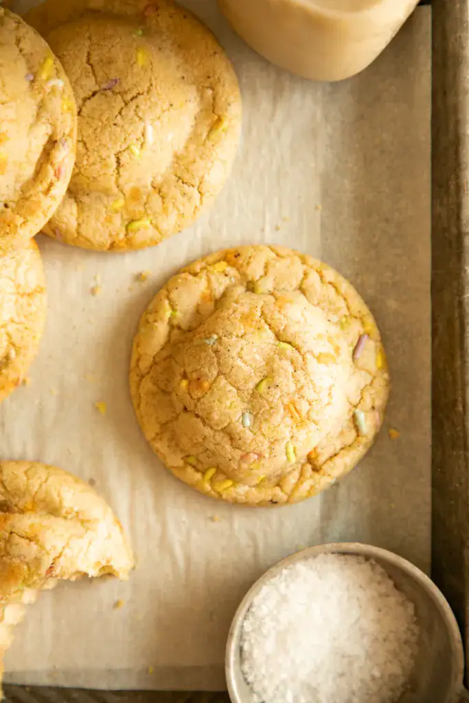 Close-up view of a baked brown butter funfetti cookie with rainbow sprinkles