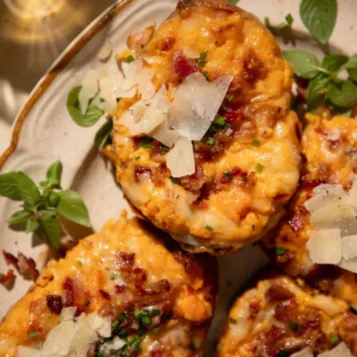 Twice baked sweet potatoes topped with white cheddar, bacon, and chives, served with sour cream.