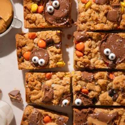 Close-up of a Halloween Monster Cookie Bar topped with a Reese’s Cup and candy eyes.