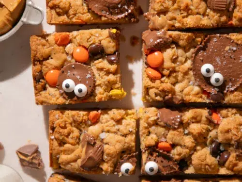 Close-up of a Halloween Monster Cookie Bar topped with a Reese’s Cup and candy eyes.