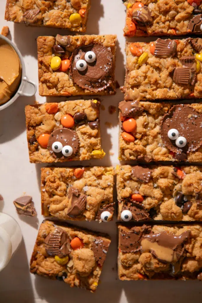 Close-up of a Halloween Monster Cookie Bar topped with a Reese’s Cup and candy eyes.
