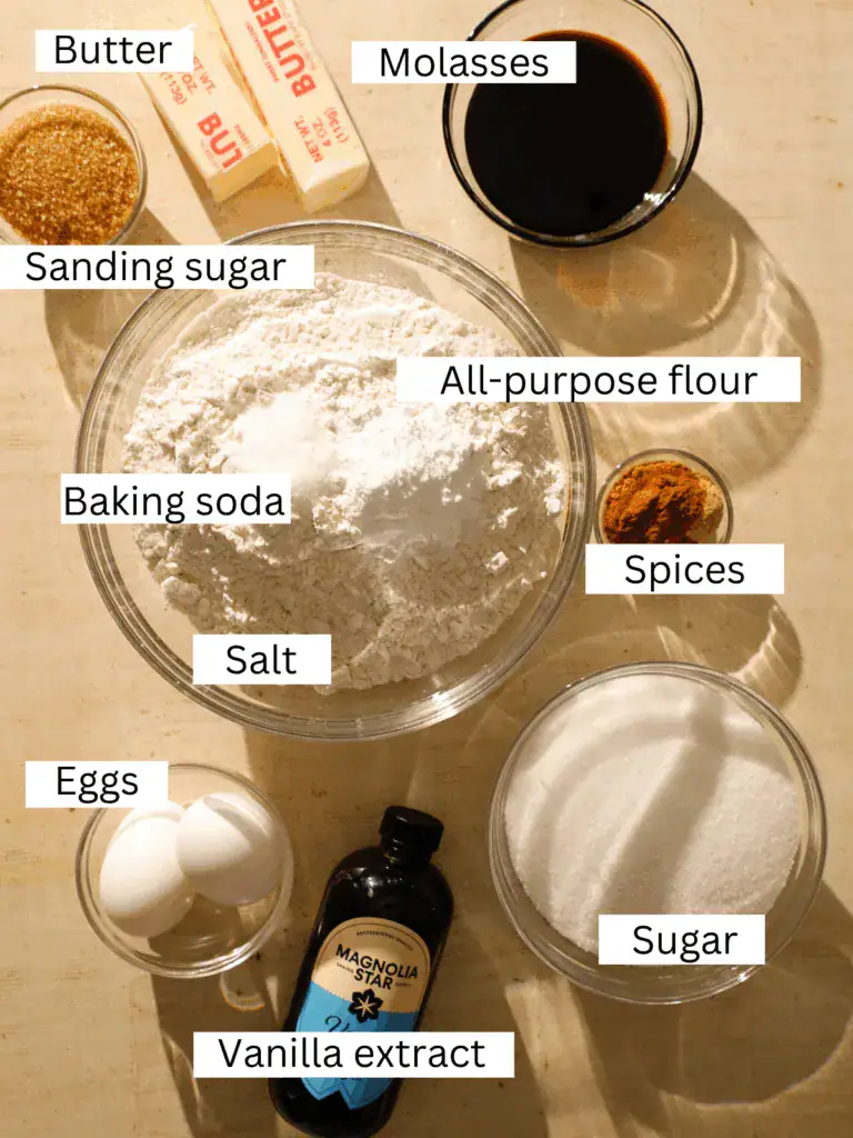 Ingredients for one-bowl old-fashioned chewy ginger cookies including butter, molasses, flour, sugar, eggs, vanilla, spices, baking soda, salt, and sanding sugar.