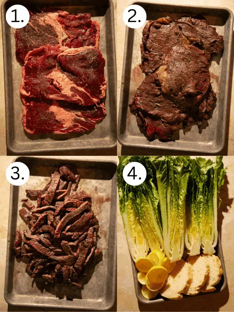 Cooked ribeye steaks resting on a sheet pan after grilling.