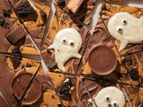 Melting white chocolate chips with coconut oil for making ghost shapes on the bark