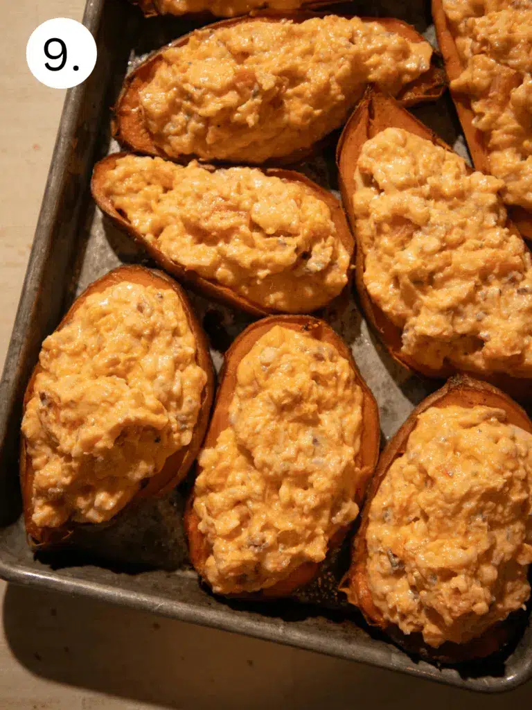 Sweet potato halves filled with creamy cheddar and bacon mixture before final bake.