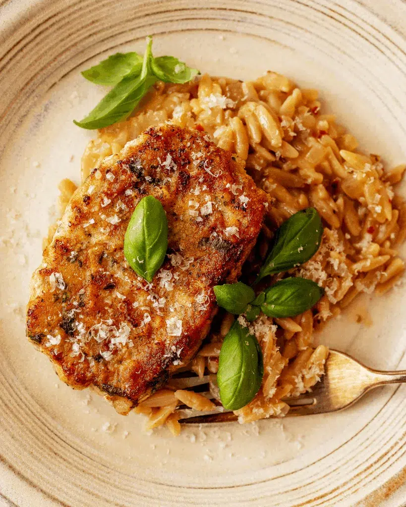 Plate with grilled pork chop and orzo
