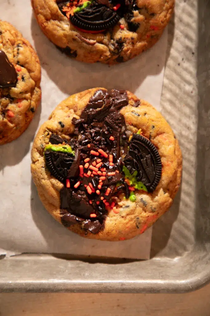 Freshly baked Halloween chocolate chip cookies loaded with Oreos, Reese’s, chocolate chunks, and sprinkles.