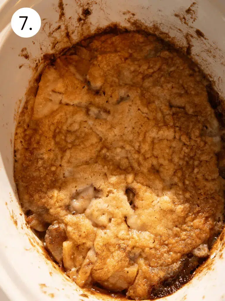 Golden brown apple dump cake baked in crockpot until bubbly and crisp on edges.