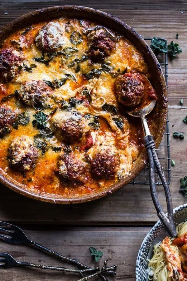 Skillet with cheesy baked meatballs