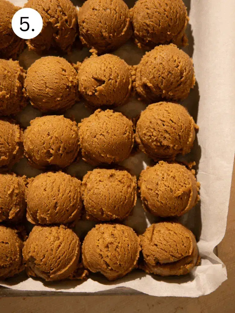 Cookie dough balls on parchment paper