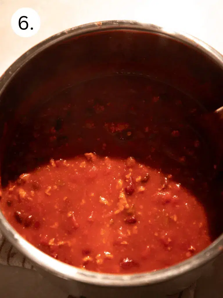 Thick, hearty turkey and bean pumpkin chili simmering in the Instant Pot after cooking