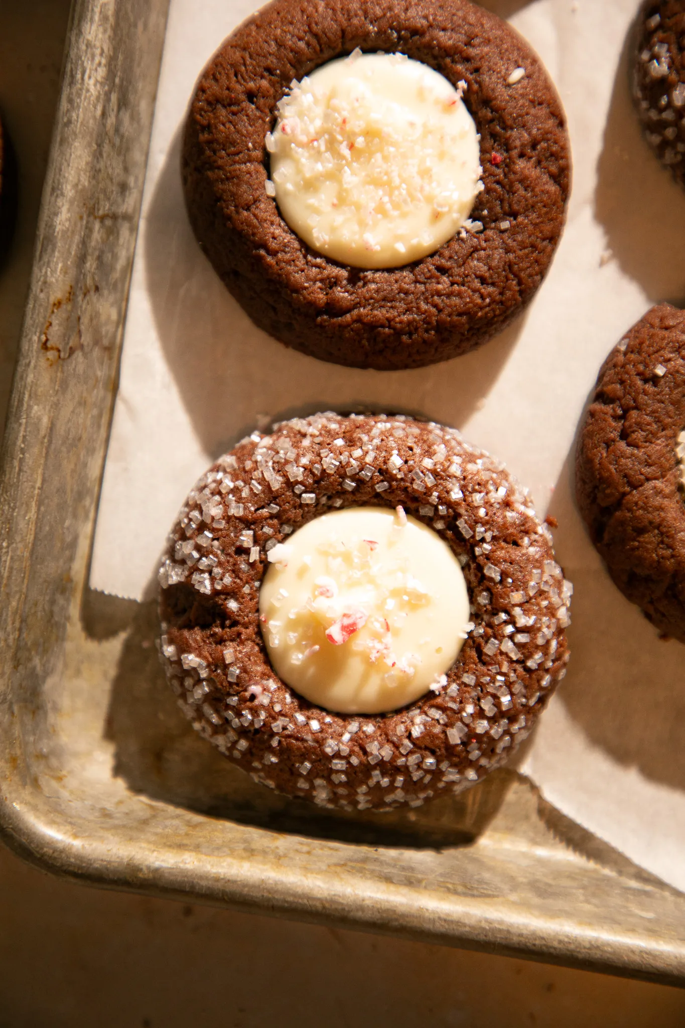 Chocolate thumbprint cookie topped with white chocolate center and crushed peppermint pieces.