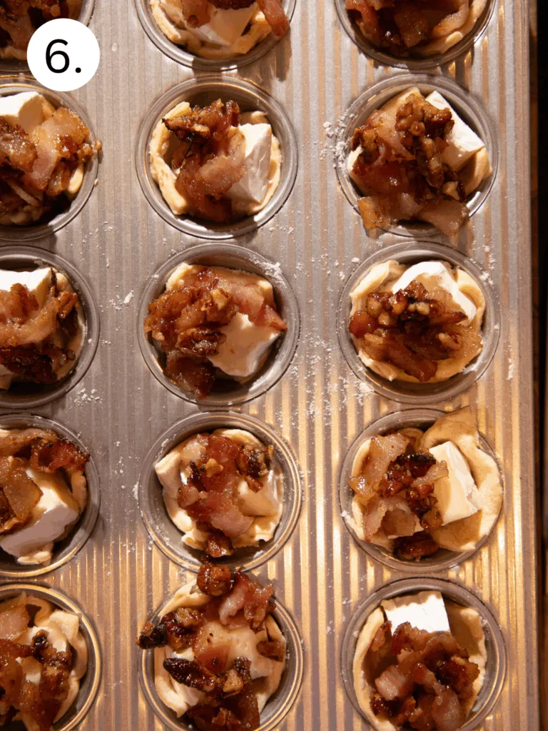 Unbaked crescent cups filled with brie and topped with maple bacon pecan mixture.