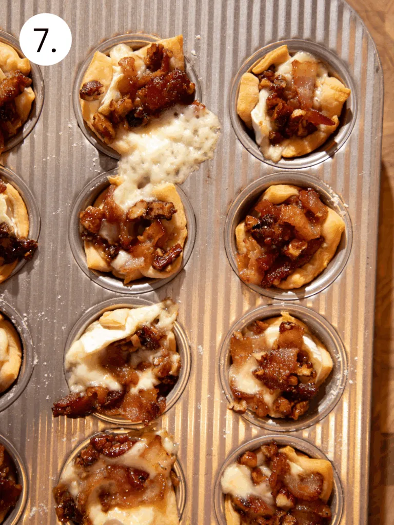 Freshly baked maple bacon brie crescent bites in a muffin tin with melted cheese.