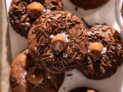 Freshly baked double chocolate espresso blossom cookies topped with chocolate kisses, chocolate sprinkles, and flaky sea salt.