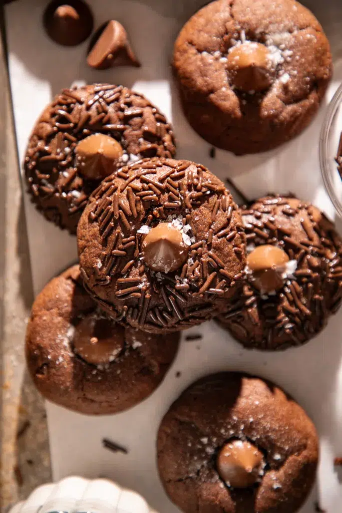 Freshly baked double chocolate espresso blossom cookies topped with chocolate kisses, chocolate sprinkles, and flaky sea salt.
